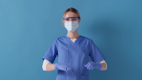 Nurse expresses love and care for her patients, shows heart sign with both hands over chest