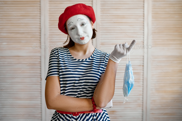 Female mime artist with medical mask