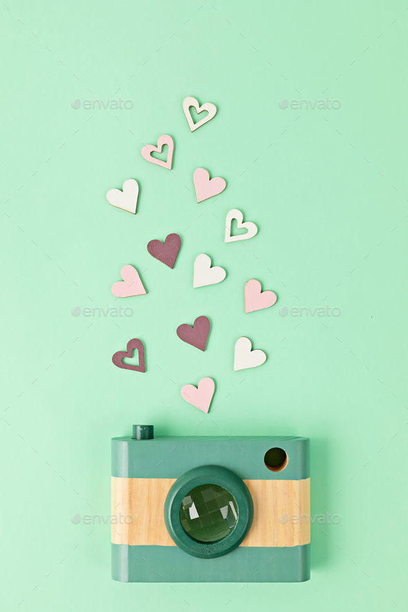 Flat lay with toy wooden camera and hearts. Social media, posts, likes, followers, online