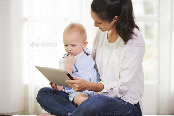 Mom and son watching cartoon Stock Photo by DragonImages | PhotoDune