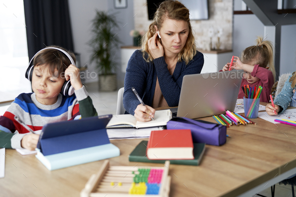 Busy mother during home office with children at home