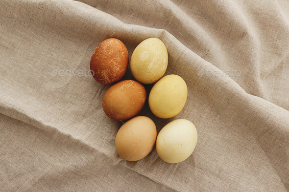 Happy Easter! Modern brown and yellow easter eggs on rustic linen cloth, ombre tones. Aesthetic
