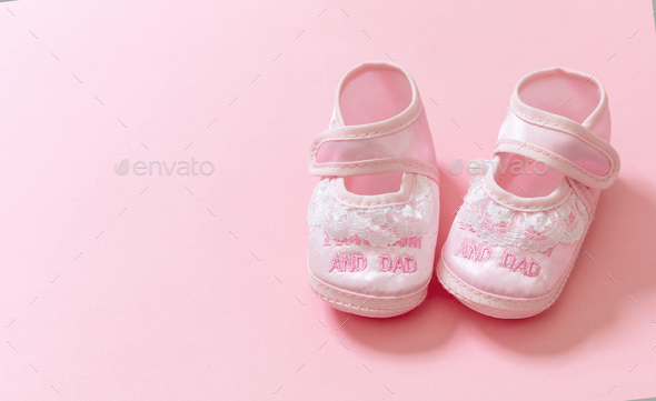 It's a girl announcement. Baby girl pink shoes on pink color background.  Stock Photo by rawf8