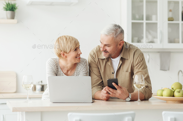 Middle aged couple on free time or weekend with tech and social media