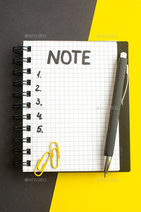top view open notepad with note and numbers inside on dark-yellow background office success