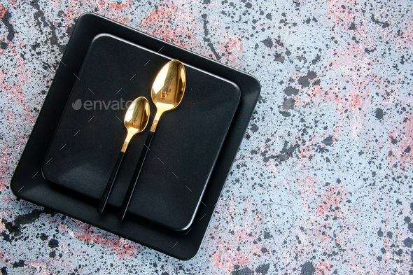 top view dark plates with golden spoons on light background cutlery food  restaurant color shade Stock Photo by KamranAydinovStudio