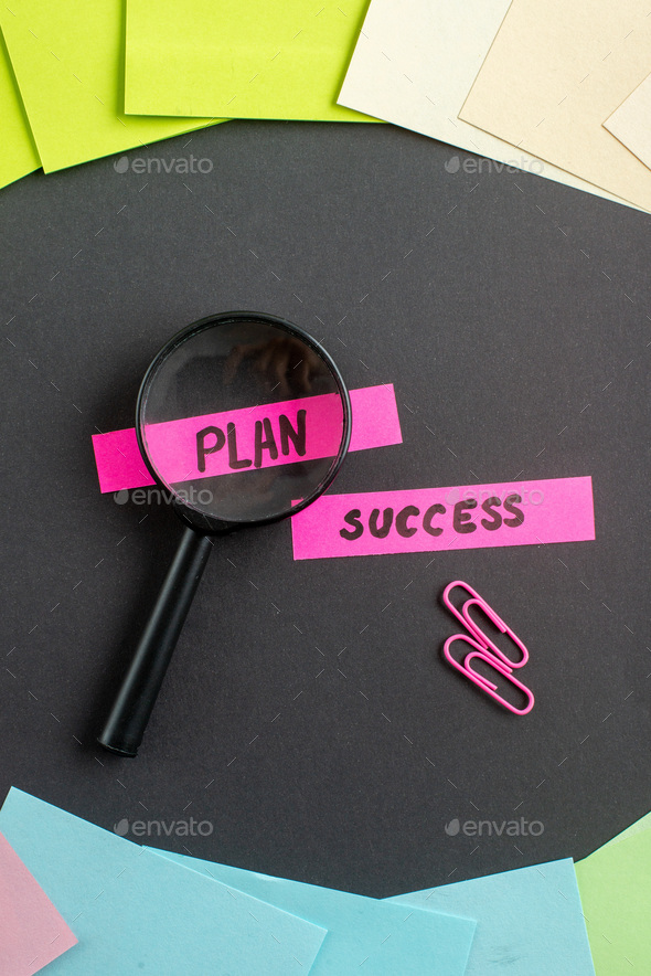 top view plan and success notes with colored stickers on dark background job teamwork marketing
