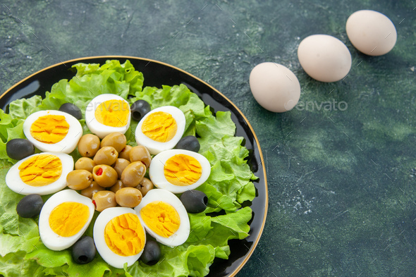 above view boiled sliced eggs with green salad and olives on dark background dish vegetable food