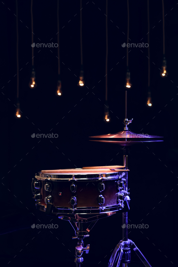 Snare drum and hihat in the dark on a blurred background with lights