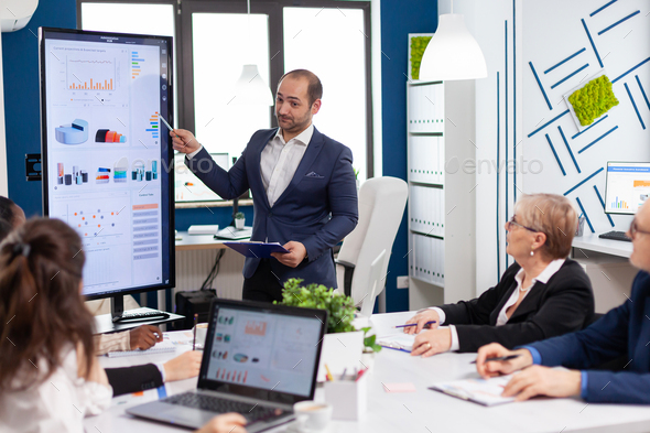 Business partner presenting company strategy to diverse team