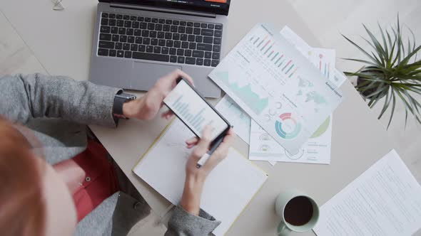 Timelapse of Financial Analyst Working at Desk on Laptop and with Documents alt