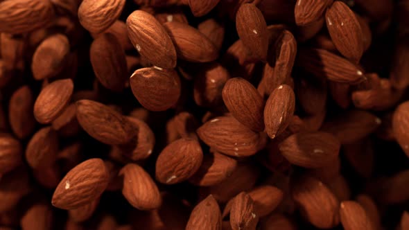 Super Slow Motion Shot of Almonds Flies After Being Exploded at 1000Fps. alt