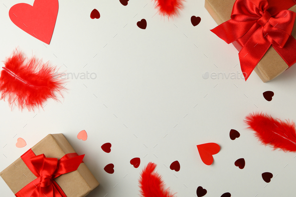 Gift boxes, hearts and feathers on white background