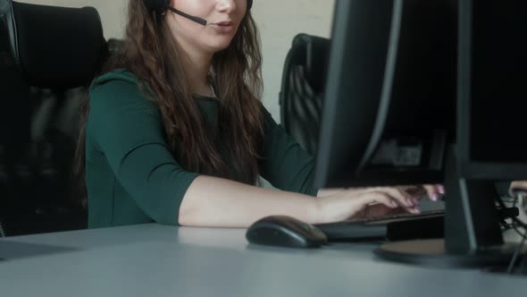 Call center operator answers  call in office and advises clients. alt
