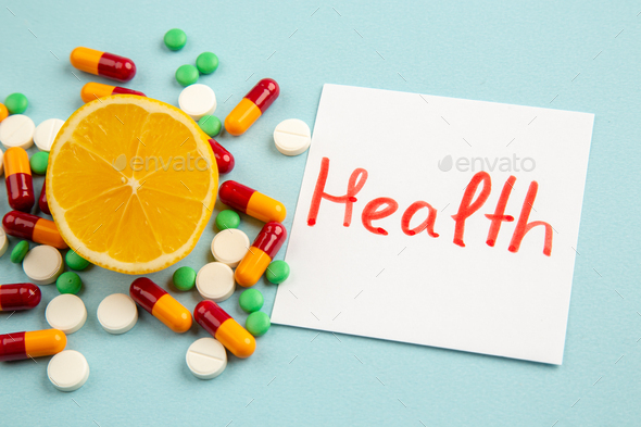 front view different pills with orange slice on light blue background pandemic virus science covid