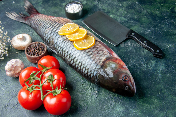 front view fresh raw fish with lemon slices and tomatoes on dark blue background shark seafood meal
