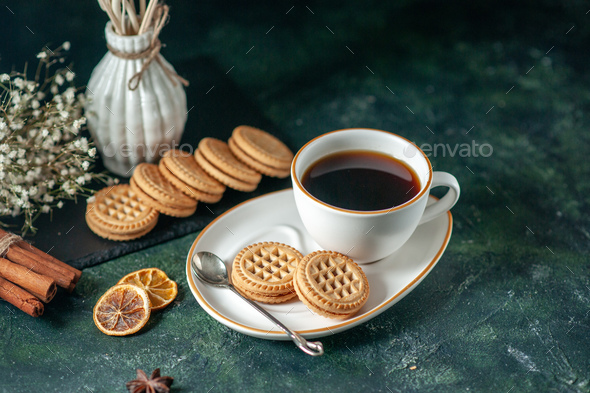 https://s3.envato.com/files/329157205/front%20view%20(cup%20of%20tea)%20with%20little%20sweet%20biscuits%20in%20white%20plate%20on%20dark%20background%20bread%20drink%20ceremony%20breakfast%20morning%20glass%20sugar%20photo%20colors.jpg