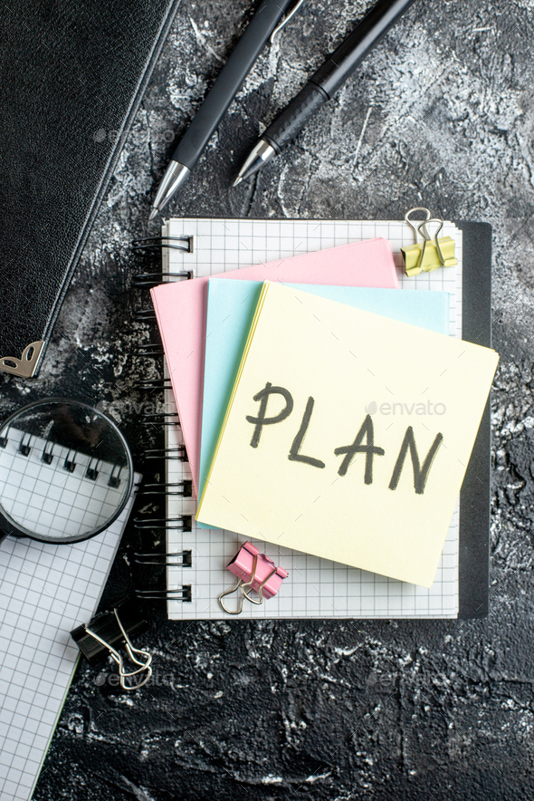 top view plan written note with colorful stickers on dark gray background student work team office