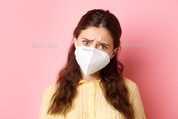 Preventive measures, health care concept. Close up of sad young woman in medical respirator express