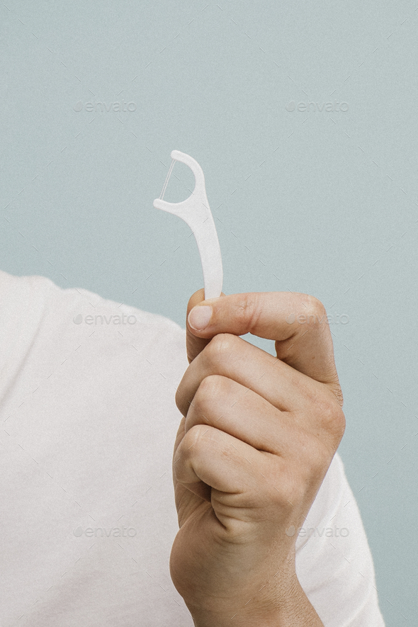 Man using dental floss - Stock Photo - Images