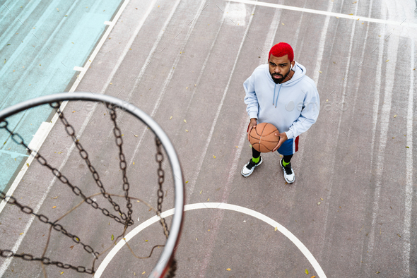 Bearded african american guy playing basketball at playground outdoors