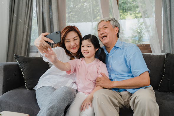 Asian grandparents selfie with granddaughter at home. Stock Photo by ...