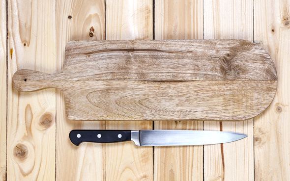 Cutting board on dark wood background, top view Stock Photo by xamtiw