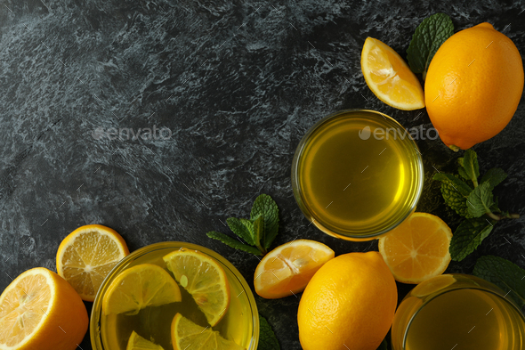 Lemon jelly, lemon slices and mint on black smokey background, top view