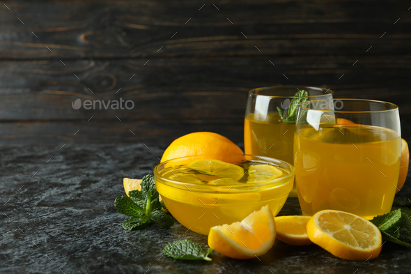 Concept of dessert with lemon jelly with lemon slices on black smokey table
