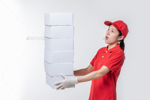 Image of a happy young delivery man in red cap blank t-shirt uniform standing with empty white.