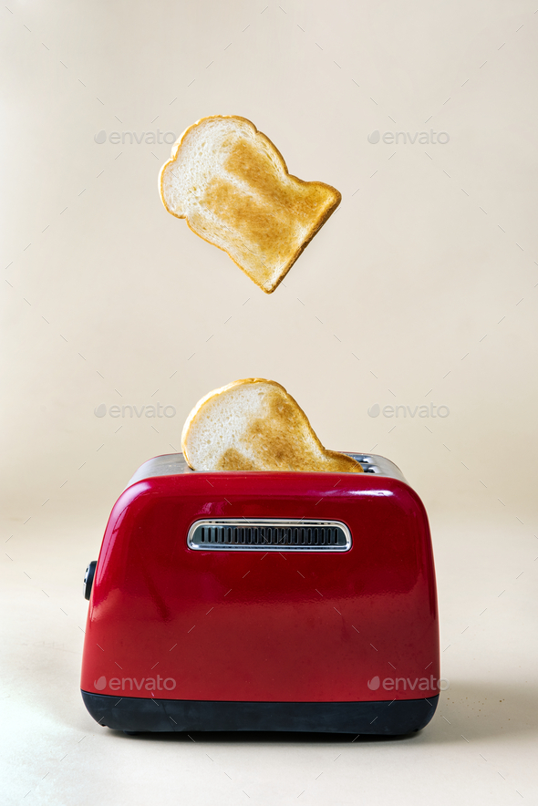 Roasted toast bread up from a red toaster Stock Photo Rawpixel