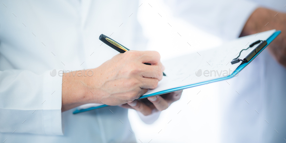 The doctor examines the patient's history in hospital or clinic, medicine health care - Stock Photo - Images