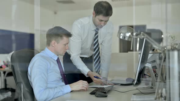 Upset Mature Businessmen Discussing on the Document in Office alt