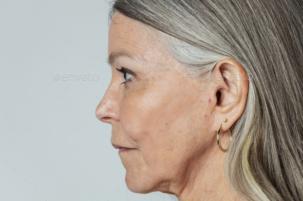 Senior woman with pierced ears in a profile shot