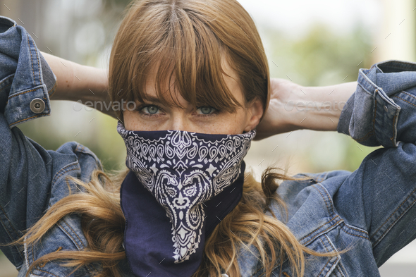 Woman using a scarf as a face mask during coronavirus outbreak