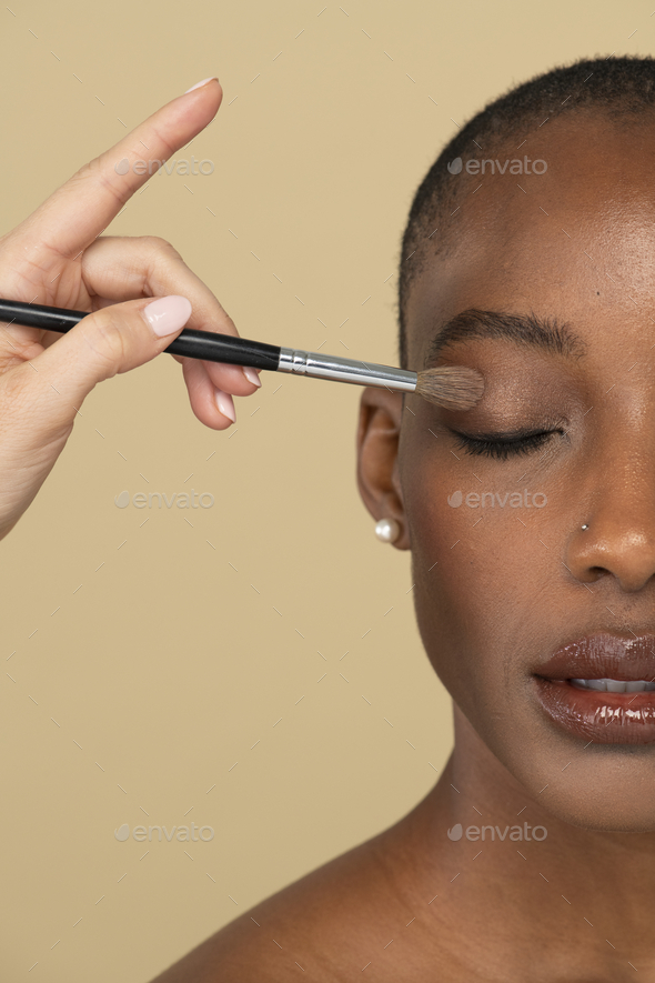 Makeup artist applying eye shadow on a