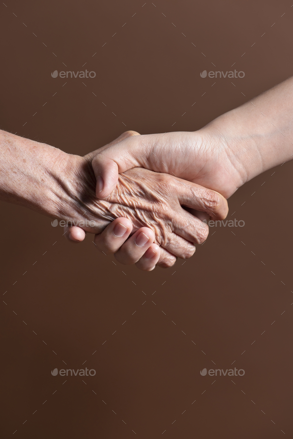 Old person and a young person shaking hands Pinterest banner - Stock Photo - Images