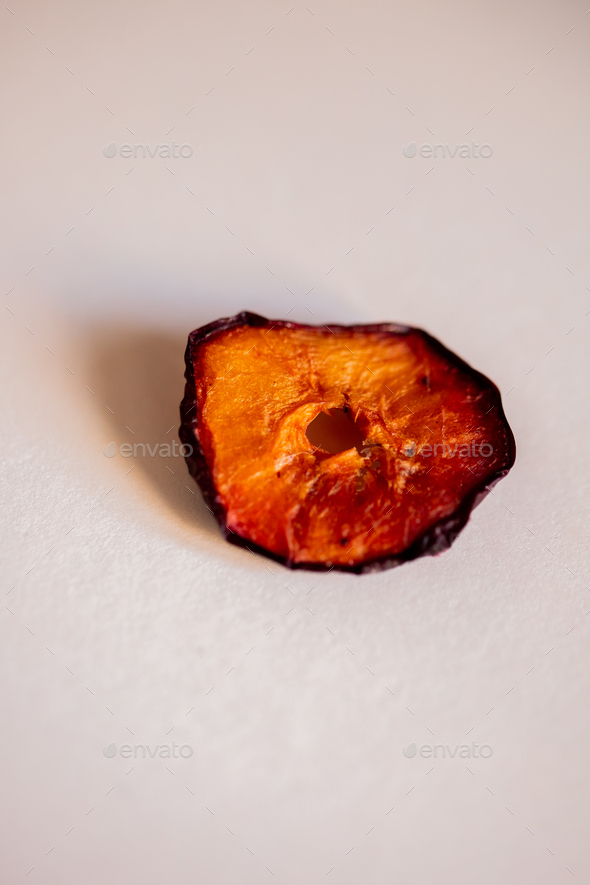 side view of dried plum slice isolated on white background