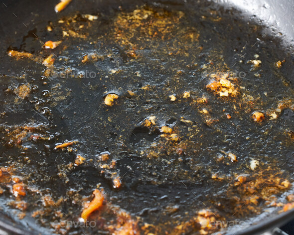 Fat and oil in frying pan, dangerous cancer causing carcinogens, used trans fat on saucepan