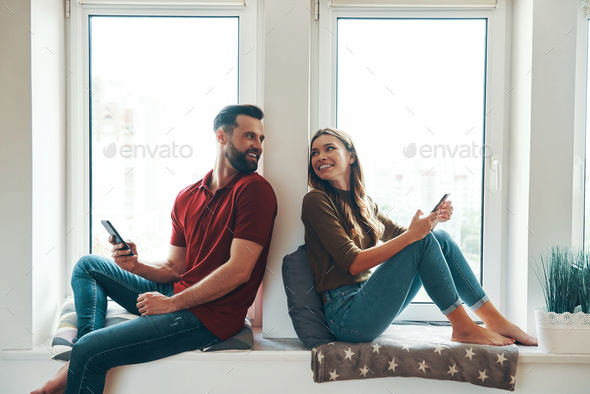 Modern young couple in casual clothing - Stock Photo - Images