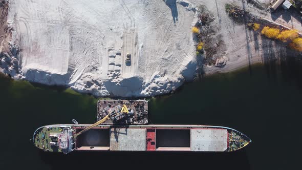Aerial top down view of loading dry cargo ship.
