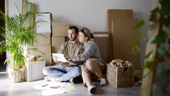 Cheerful Family Makes Project of New Apartment Decoration