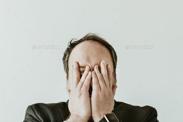 Terrify man covering face with his hands - Stock Photo - Images