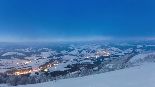 Time Lapse Video with Blue Sky Fog and Snow of a Starry Sky Over Snowy Ski Resort in the Mountains