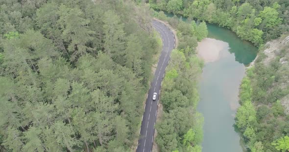 Aerial View of Electric Car Driving on a Road Close to Cascade De La Vis France