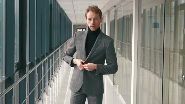 Fashion handsome man posing on camera and indicating. Successful businessman posing and pointing on alt