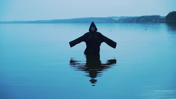 Evil Witch in a Black Hood in the River alt