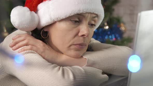 Female in Santa Hat By Notebook in Room alt