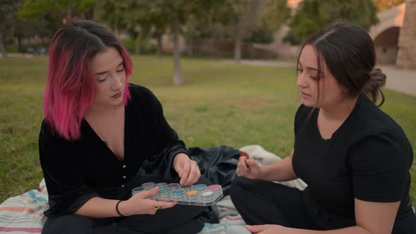Two European Friends Talking About Cosmetics in a Park alt