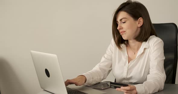 Female Manager Working in the Office Young Woman Making Online Shopping By Laptop Holding Credit